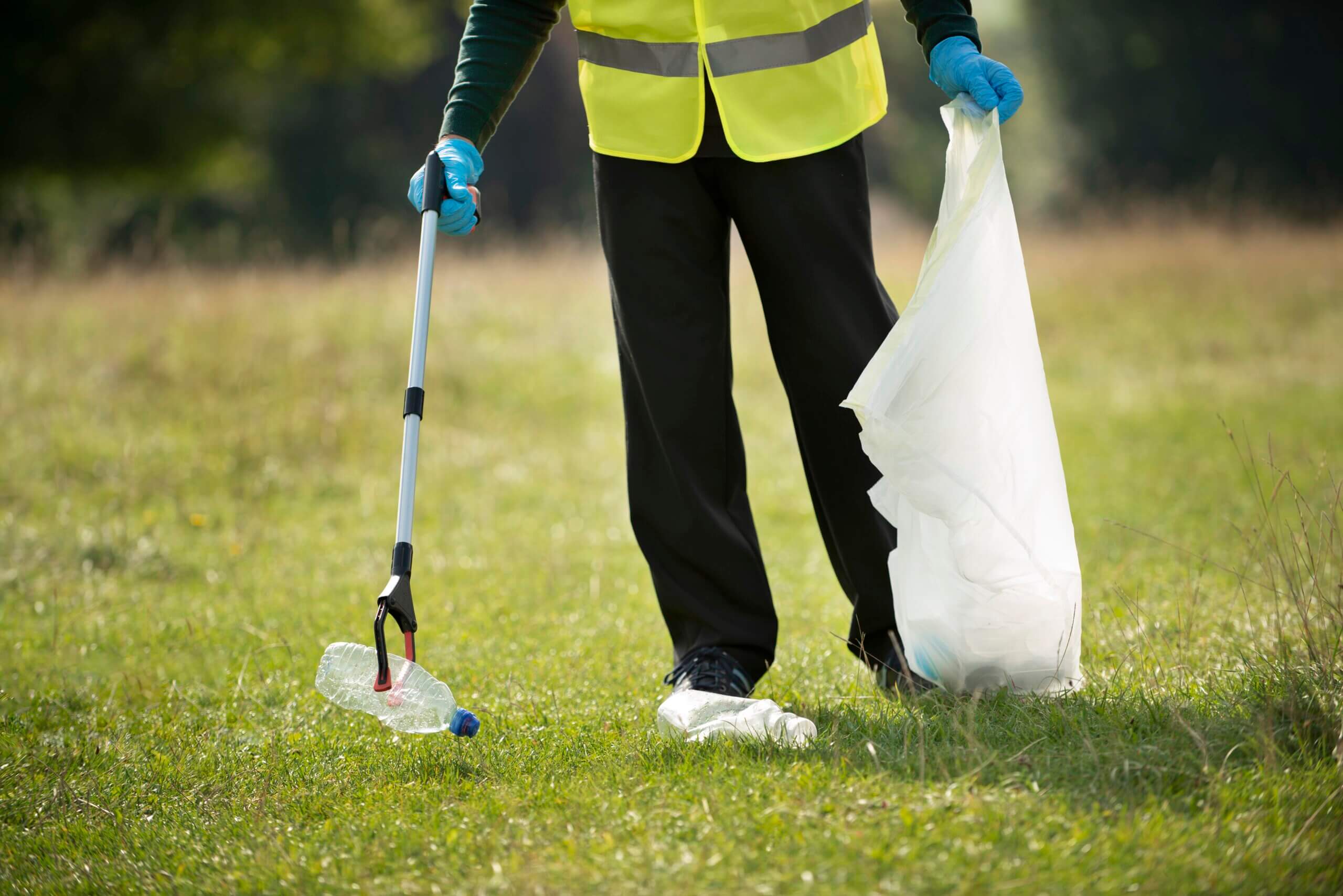 person doing community service by collecting trash scaled